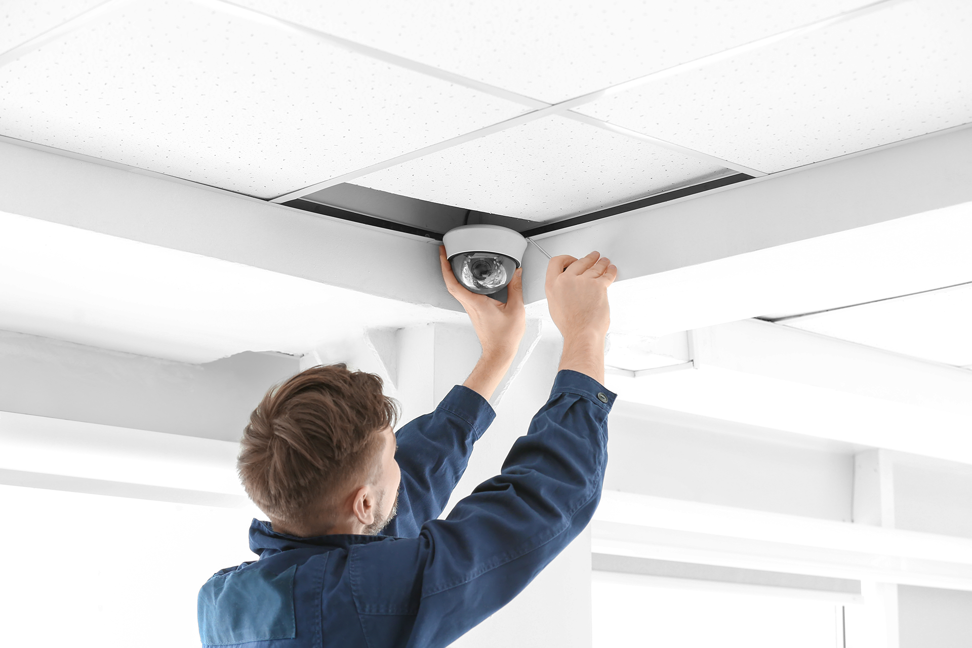 Technician installing CCTV system